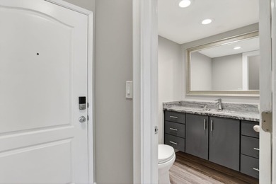 This condominium features an open kitchen, equipped with new - photo 14
