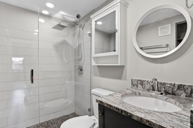 This condominium features an open kitchen, equipped with new - photo 18