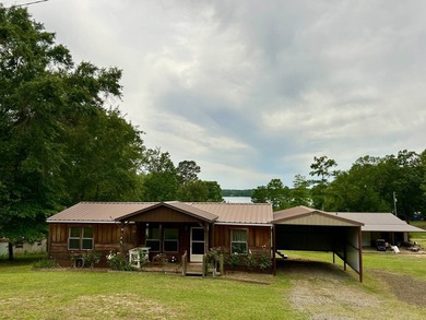 Nestled on approximately .54 acres along the water with a - photo 1