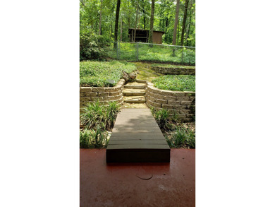 Nestled on a beautifully wooded and landscaped double lot, this - photo 27
