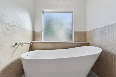 Located in a quiet cul-de-sac within a gated community, this