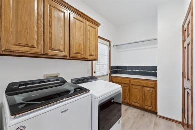 Located in a quiet cul-de-sac within a gated community, this