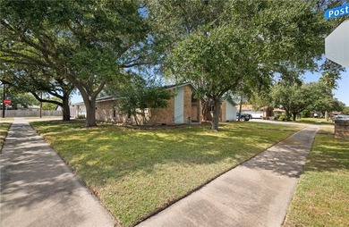 This 3-bed, 2-bath brick home sits on a large corner lot in an - photo 2