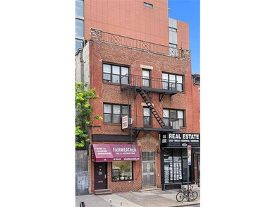Rare opportunity to own a solid brick mixed-use building in the - photo 1