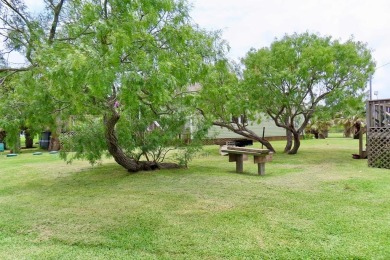 Nestled in the peaceful Copano Cove area, this charming