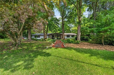 Tucked among mature trees on a large private lot in the - photo 2