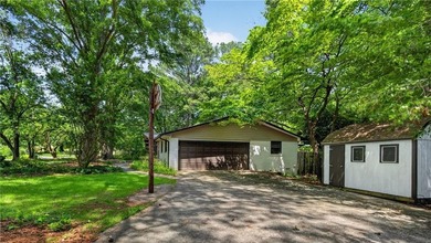 Tucked among mature trees on a large private lot in the - photo 3