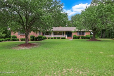 Nestled on a beautifully landscaped triple lot, this - photo 1
