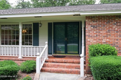 Nestled on a beautifully landscaped triple lot, this - photo 3