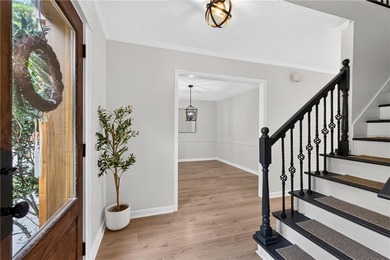 Tucked into a private wooded lot with a stunning lake view in - photo 11