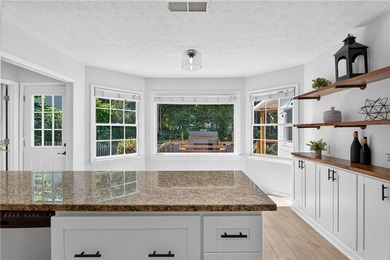 Tucked into a private wooded lot with a stunning lake view in - photo 16