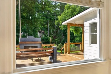 Tucked into a private wooded lot with a stunning lake view in - photo 17