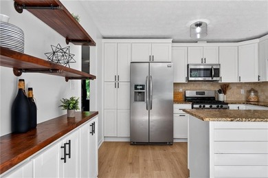 Tucked into a private wooded lot with a stunning lake view in - photo 18