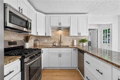 Tucked into a private wooded lot with a stunning lake view in - photo 19