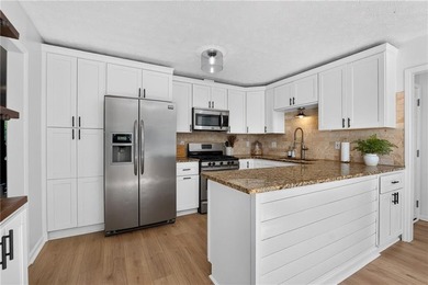 Tucked into a private wooded lot with a stunning lake view in - photo 20