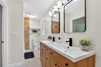 Tucked into a private wooded lot with a stunning lake view in - photo 35