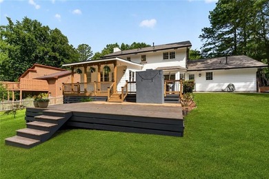 Tucked into a private wooded lot with a stunning lake view in - photo 50