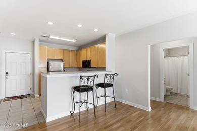 Perched on the top floor as a desirable corner end unit, this 3 - photo 9