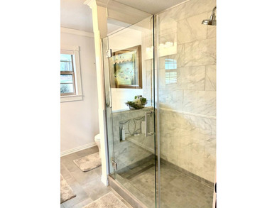 A refined waterfront retreat showcasing custom materials - photo 11
