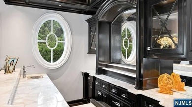 Welcome to this custom-built estate situated high atop the - photo 13