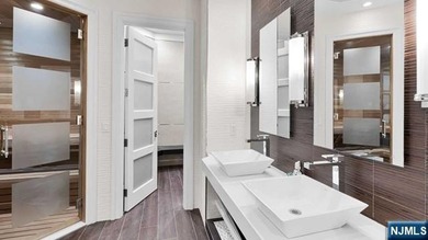 Welcome to this custom-built estate situated high atop the - photo 40