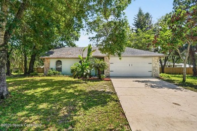 Set on an oversized .46-acre lot with mature trees, this - photo 2