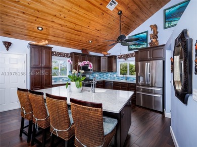 A rare waterfront estate along a 200-foot wide canal with a - photo 10