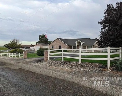 This well-maintained 3-bedroom, 2-bathroom brick home sits on 5