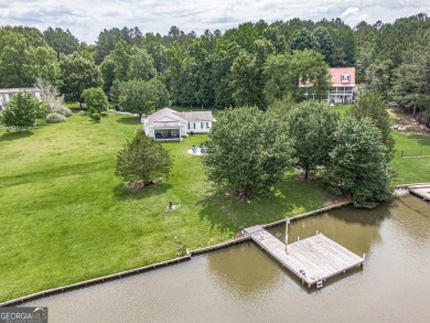 WHAT AN OPPORTUNITY!   One story home with water frontage on - Lake Home For Sale in Eatonton, Georgia