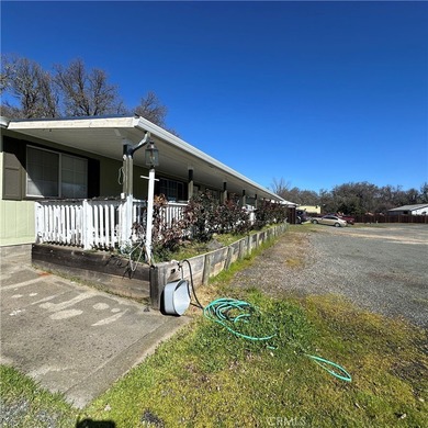 This property features a charming 3-bedroom, 2-bath manufactured - photo 4
