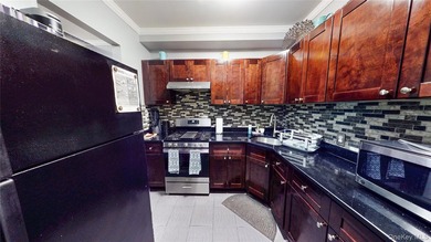 This beautifully maintained legal 3-family semi-detached home - photo 5