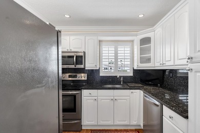 Welcome to this beautifully updated villa, featuring a spacious - photo 14