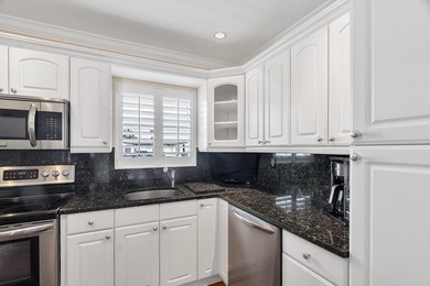 Welcome to this beautifully updated villa, featuring a spacious - photo 15