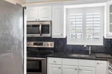 Welcome to this beautifully updated villa, featuring a spacious - photo 17