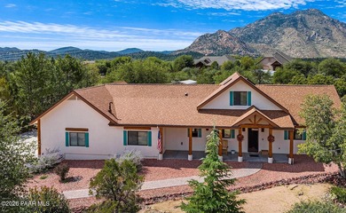 With a gorgeous backdrop of Granite Mountain, this Prescott home
