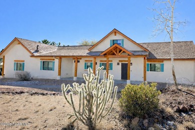 With a gorgeous backdrop of Granite Mountain, this Prescott home