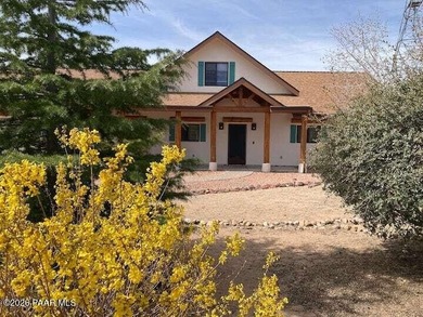 With a gorgeous backdrop of Granite Mountain, this Prescott home