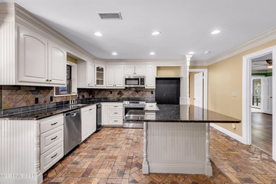 Set on 2.36 acres shaded by beautiful oak trees, this Gulfport - photo 12