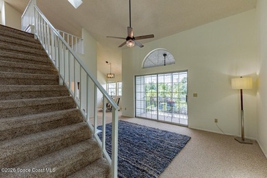 This two-story condo has high vaulted ceilings, skylights, and a - photo 6