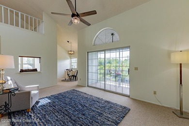 This two-story condo has high vaulted ceilings, skylights, and a - photo 7