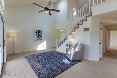 This two-story condo has high vaulted ceilings, skylights, and a - photo 10
