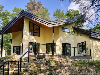 Nichee sur les rives paisibles du lac a l'Ile, cette residence - photo 4