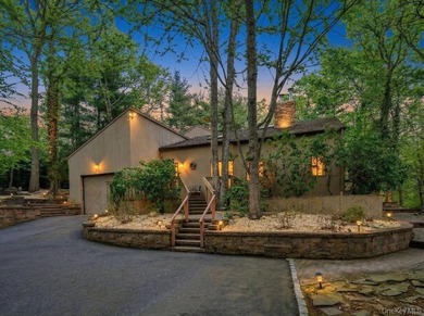 Tucked away on a beautifully landscaped 3/4-acre property, this - photo 1