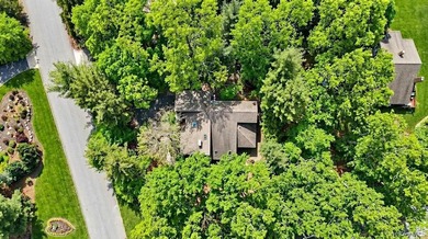 Tucked away on a beautifully landscaped 3/4-acre property, this - photo 3