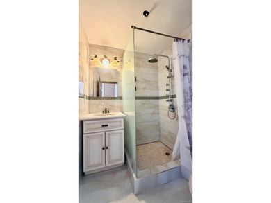 This charming one-family home offers three bedrooms, two and a - photo 9