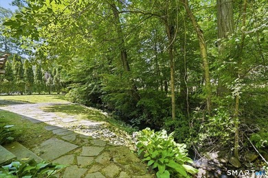 Privately sited on a flat .39-acre lot with mature landscaping - photo 5