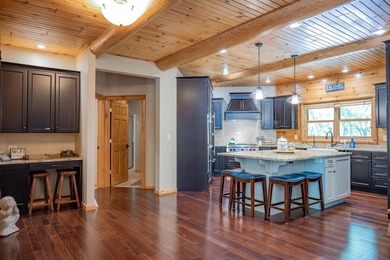 Sweeping lake views in this custom log retreat designed for - photo 11