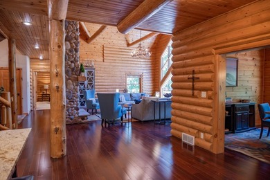 Sweeping lake views in this custom log retreat designed for - photo 12