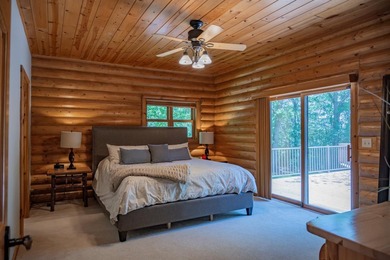 Sweeping lake views in this custom log retreat designed for - photo 13