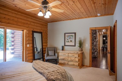 Sweeping lake views in this custom log retreat designed for - photo 14
